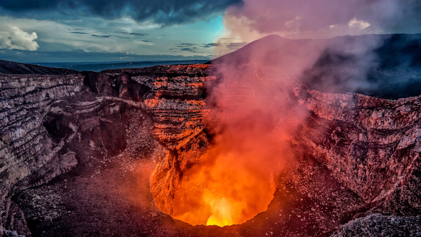 Volcano crater eruption with flowing lava and smoke.  The Masaya Volcano near Managua, Nicaragua main crater after sunset.; Shutterstock ID 1071081989; your: -; gl: -; netsuite: -; full: -