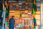 African man with fabric in market ; Shutterstock ID 1486027394; your: Brian Healy; gl: 65050; netsuite: Lonely Planet Online Editorial; full: Best times to visit Ghana