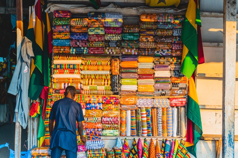 African man with fabric in market ; Shutterstock ID 1486027394; your: Brian Healy; gl: 65050; netsuite: Lonely Planet Online Editorial; full: Best times to visit Ghana