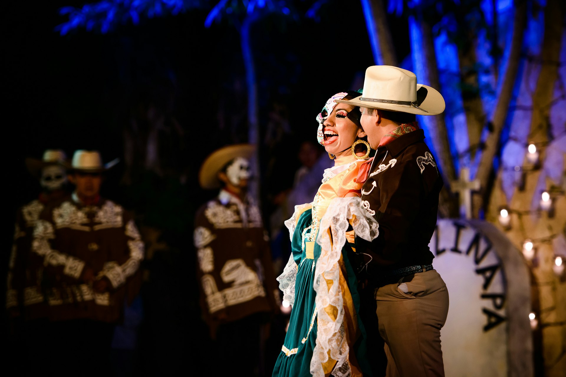 Dancers in costume embrace at a of Day of the Dead (Día de Muertos) celebration at Xcaret, Playa del Carmen, Quintana Roo, Mexico