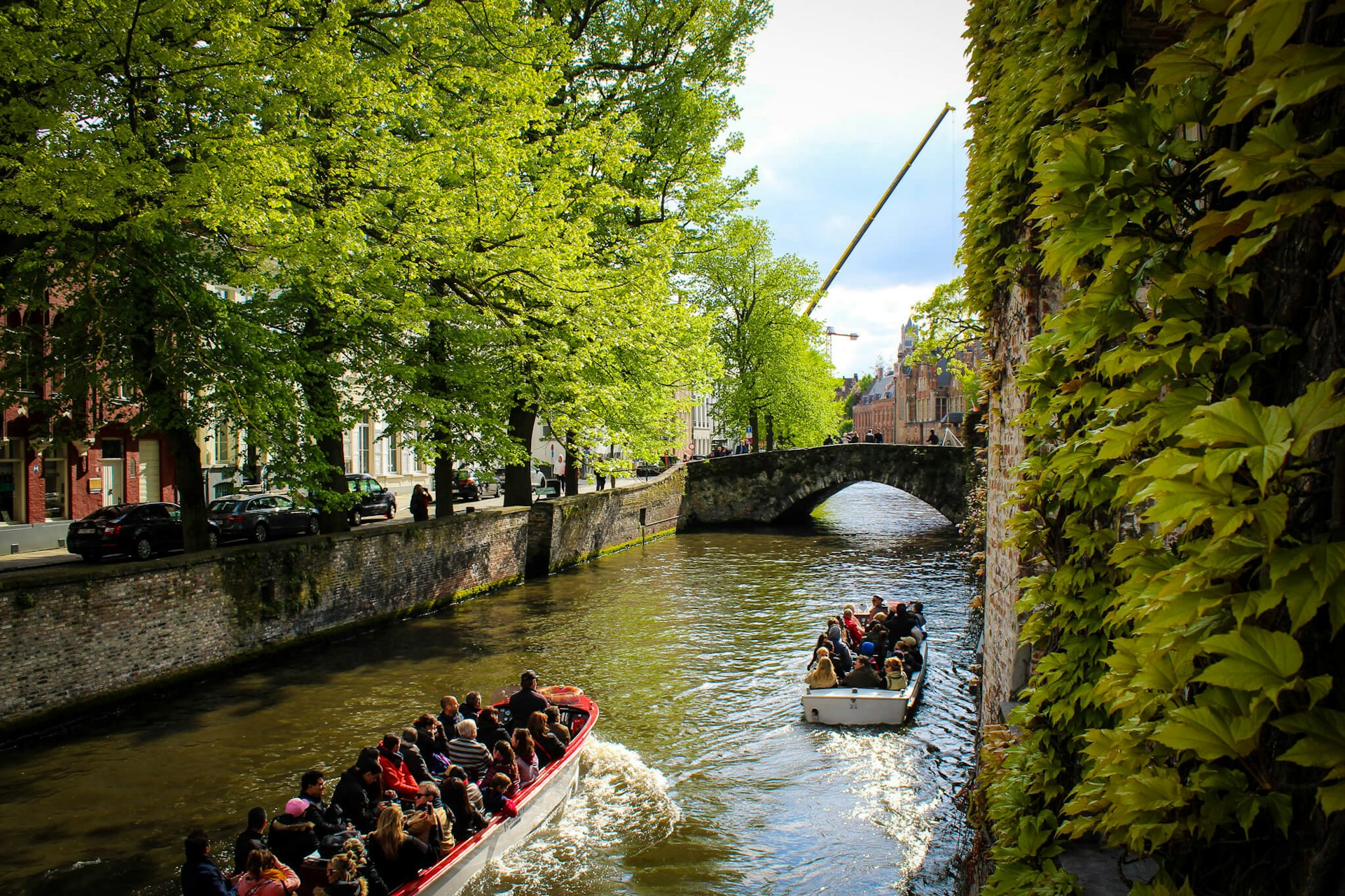 Two small canal boats take tourists around the canals of a small city