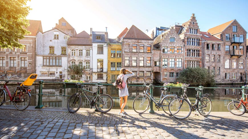 Women cycling by the canals of Ghent, Belgium