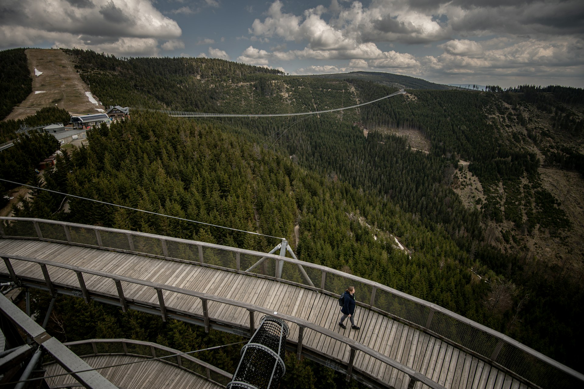 A visitor on Sky Walk with Sky Bridge 721 behind him in Czech Republic.