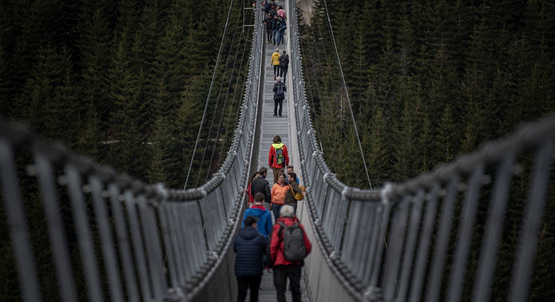 Visitors walk on the Sky Bridge 721, the world's longest suspension pedestrian bridge in Dolni Morava, Czech Republic 