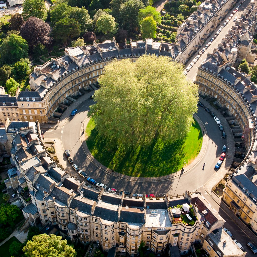 The Circus, one of the architectural centerpieces of the historic city of Bath is seen from the air – a circle of buildings sits around a large central tree © Matt Cardy / Getty Images
