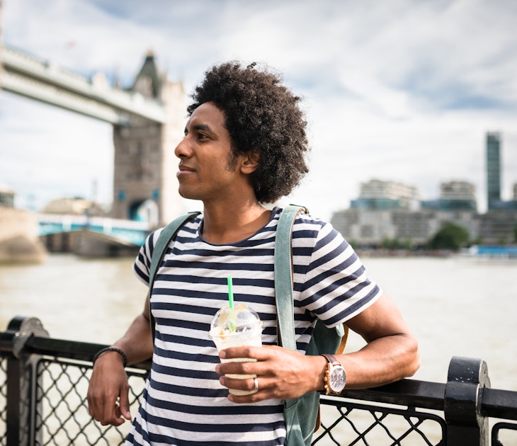 A tourist relaxing in front of Tower Bridge, London