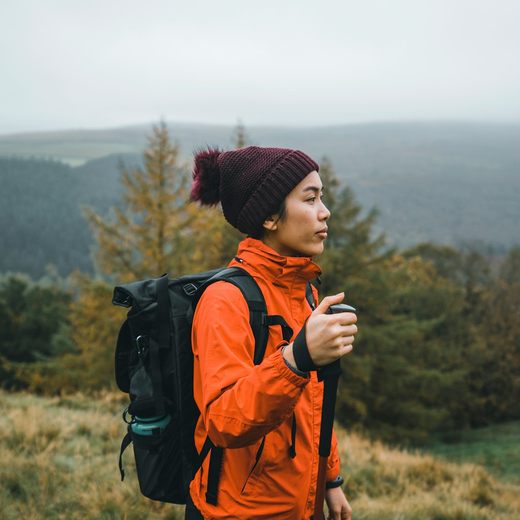 Female with red jacket exploring trekking in mountain National Park; Shutterstock ID 1986990029; your: Claire Naylor; gl: 65050; netsuite: Online ed; full: Peak District things to do