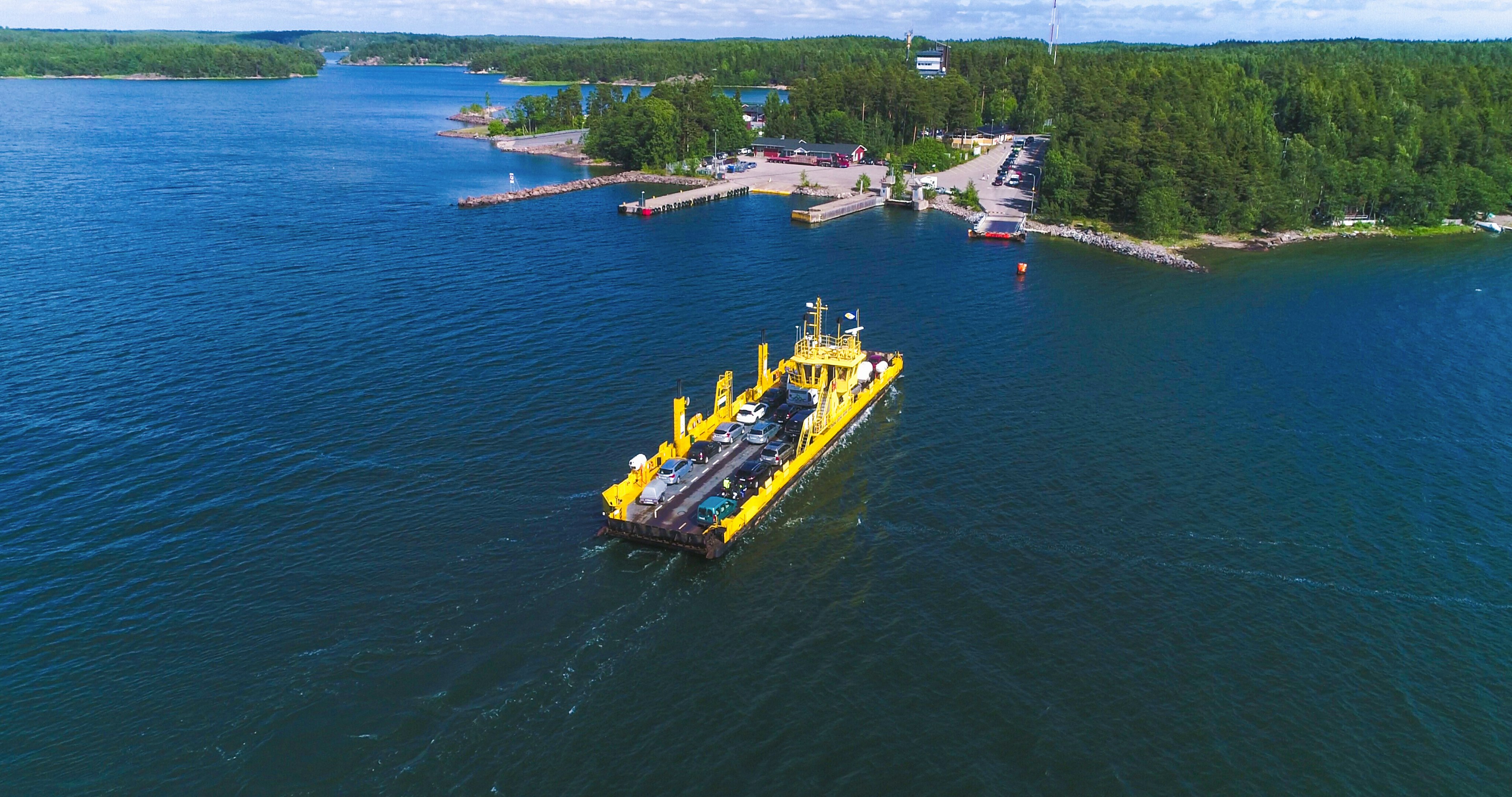 Aerial view over a cable ferry floating between Korppo and Nagu on a sunny summer day in the Turku Archipelago, Finland, Europe