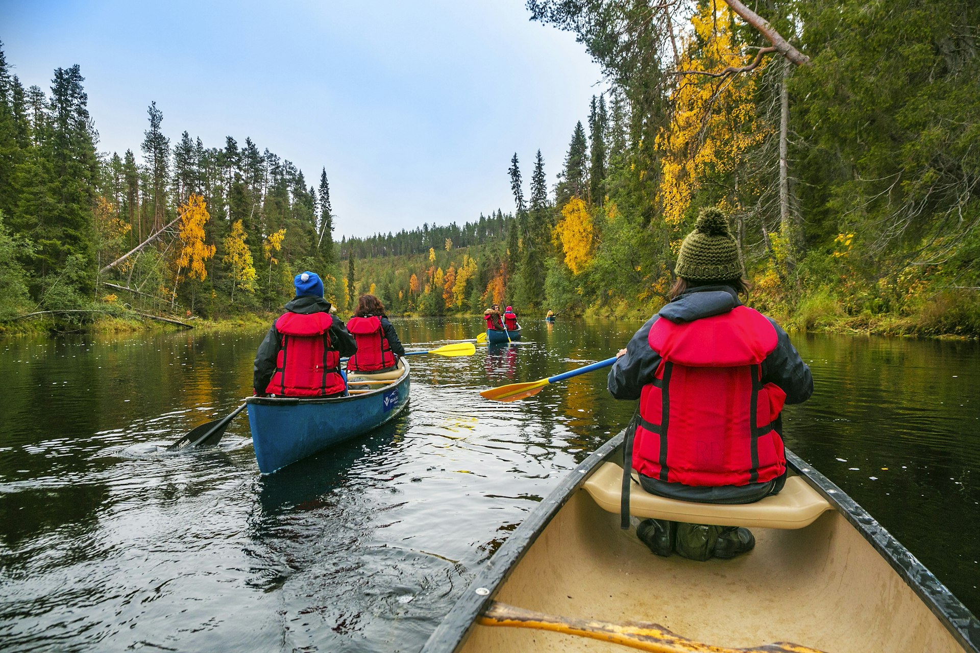 Several kayakers make their way through the water in Oulanka National Park in Finland