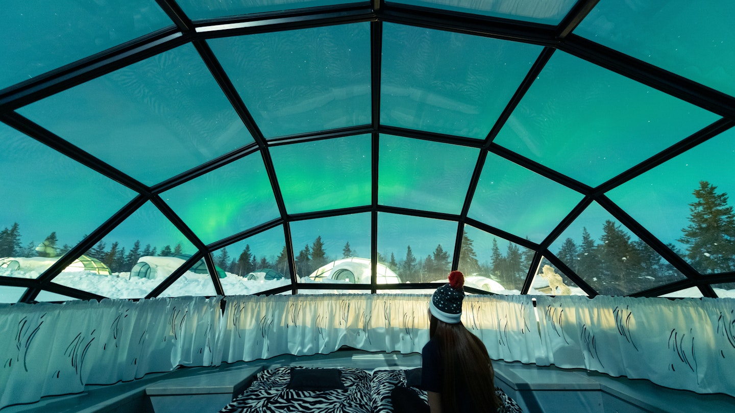 Aurora borealis, also known as Northern lights shining in the night sky seen from Glass Igloos, Kakslauttanen Arctic Resort West Village, Saariselkä, Lapland, Finland.