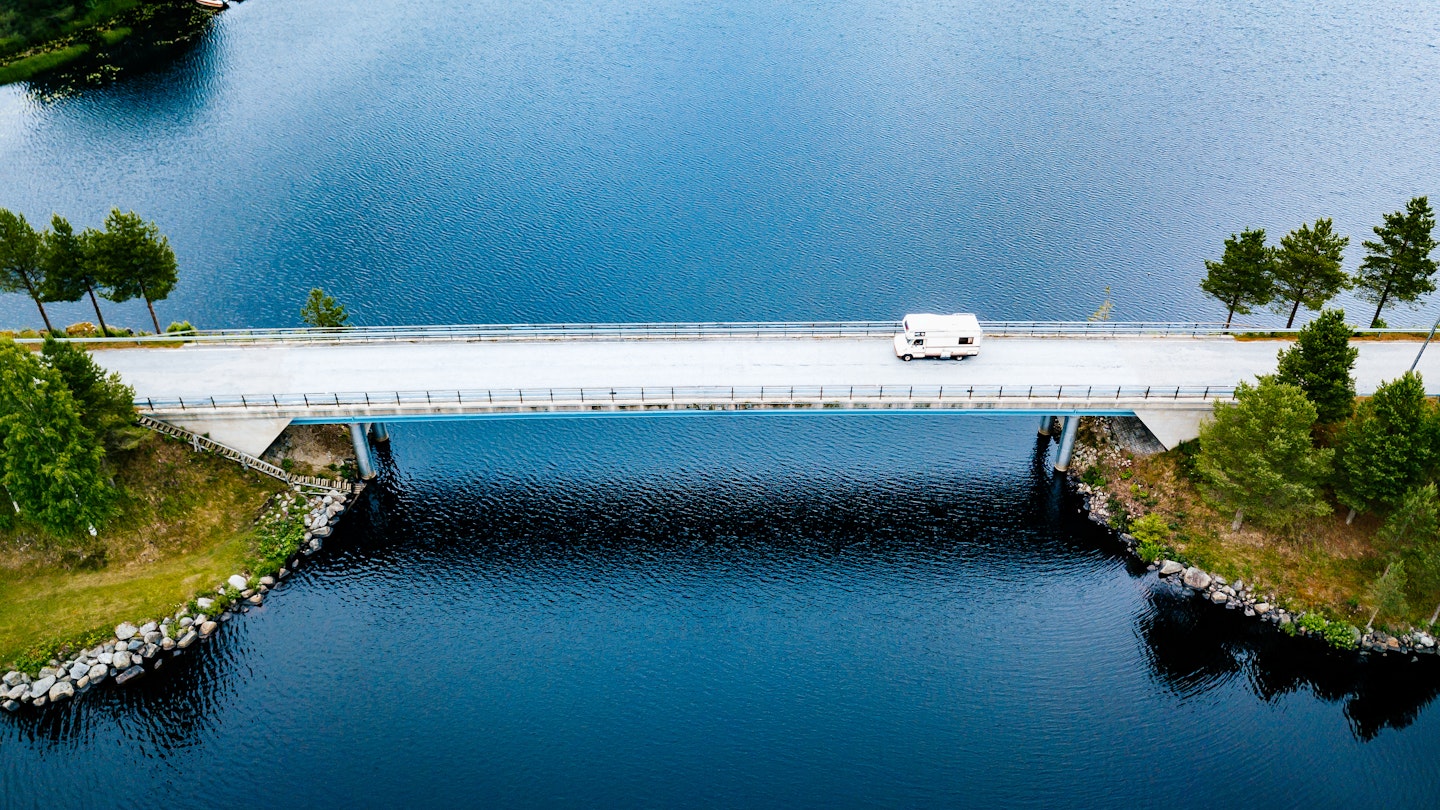 Aerial view Caravan trailer or Camper rv on the bridge over the lake in Finland. Summer holiday trip.; Shutterstock ID 1951837498; your: Brian Healy; gl: 65050; netsuite: Lonely Planet Online Editorial; full: Best road trips in Finland