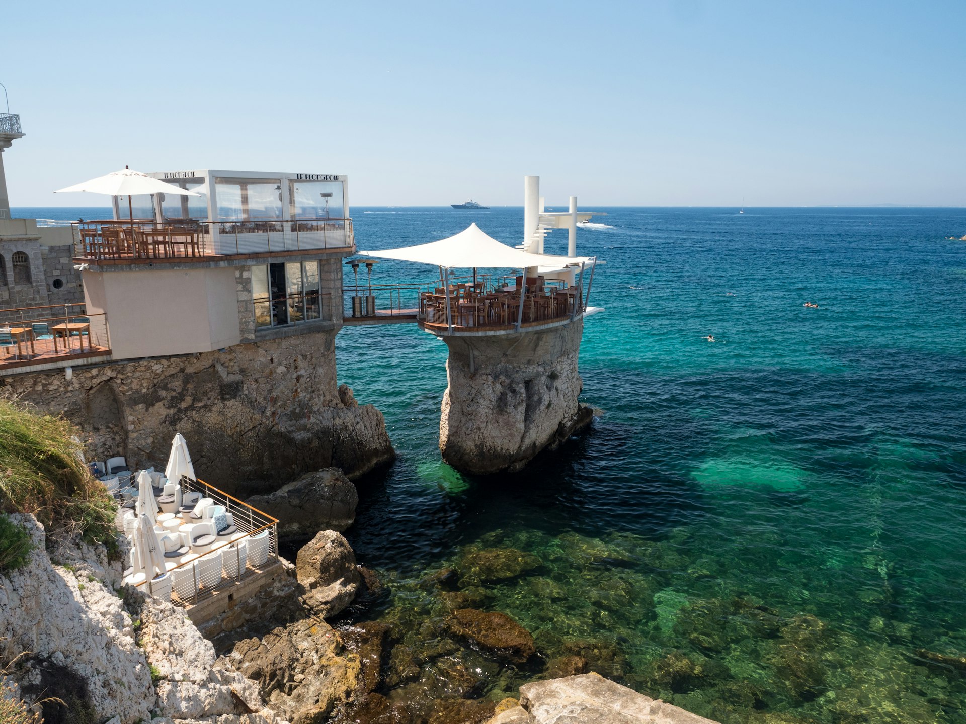 A wide view of the terrace of Le Plongeoir restaurant by La Réserve beach on the Mediterranean Sea, Nice, Côte d’Azur, France