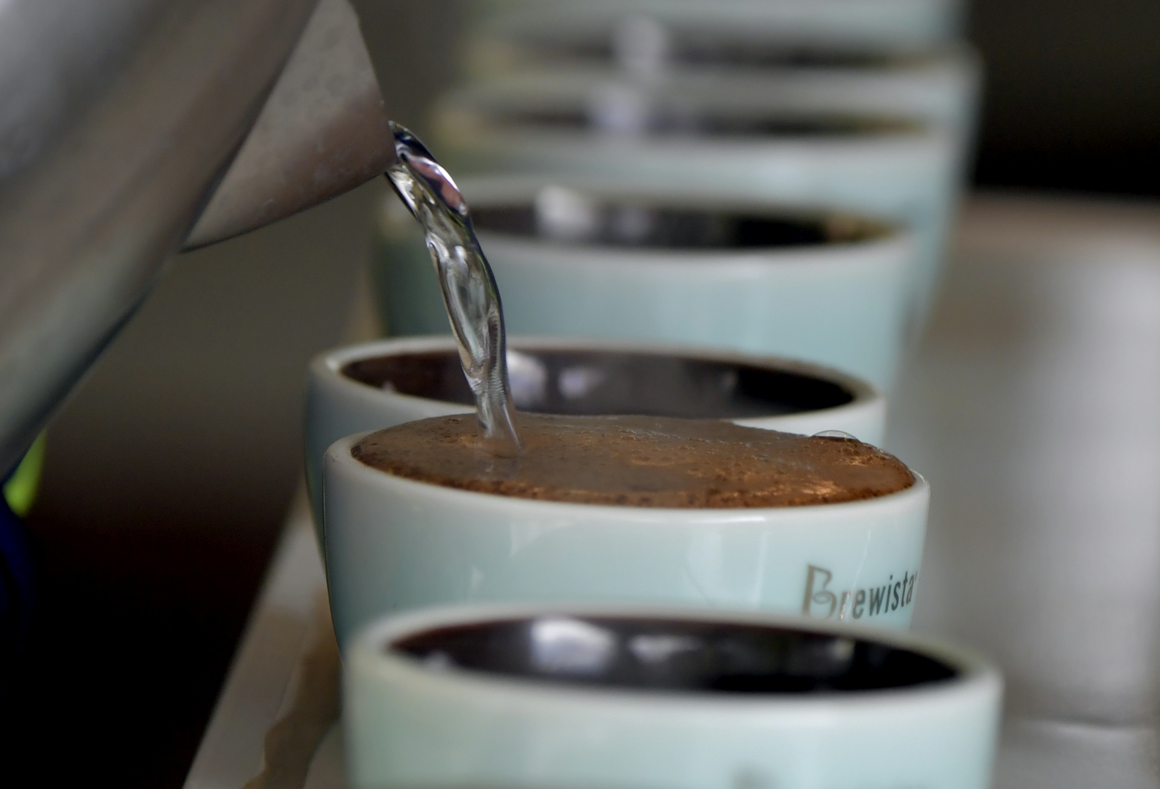 A barista pours hot water into a cup of Geisha Natural coffee in Boquete, Panama.