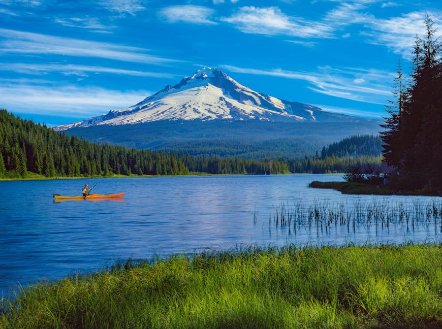 A kayaker on Trillium Lake with the reflection of Mt. Hood