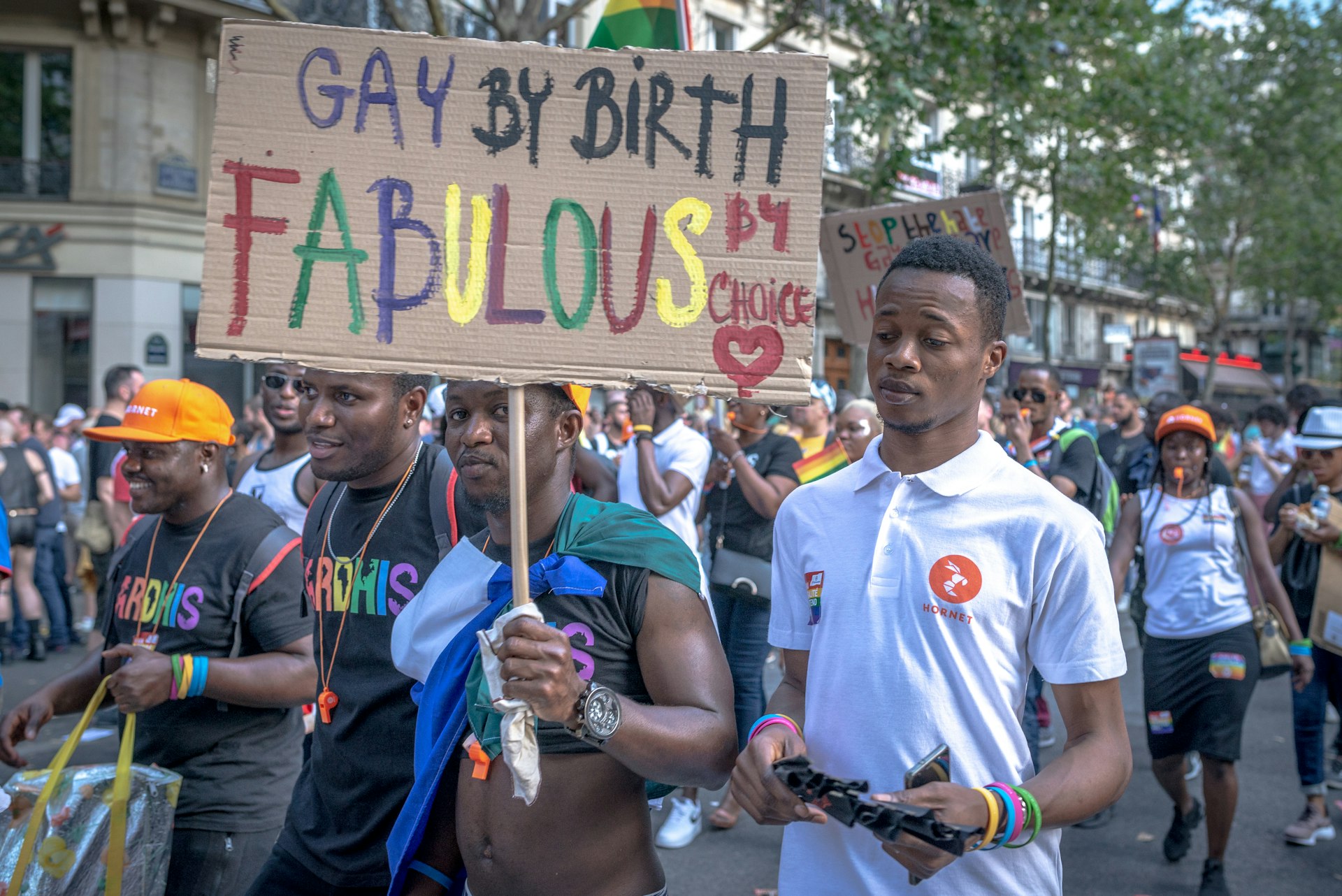 A group of young black men march in the Paris Pride parade