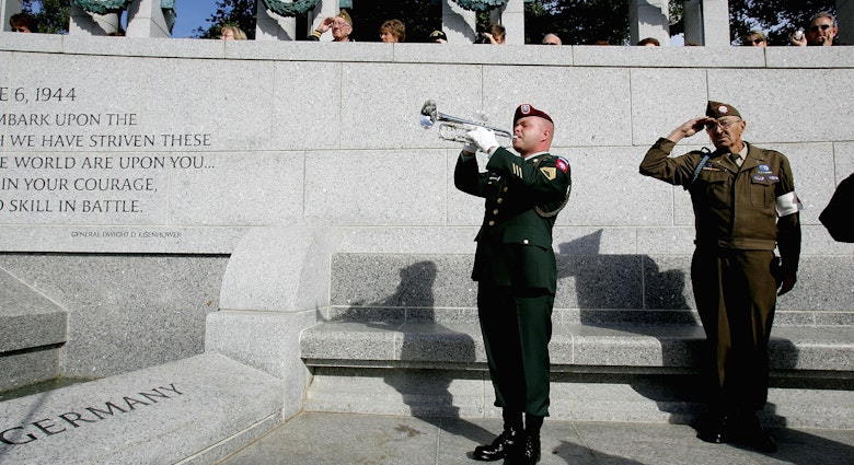 Nation's Capitol Observes Veterans Day - stock photo
WASHINGTON - NOVEMBER 11: U.S. Army staff sergeant Daniel H. Marshall from the 82nd Airborne plays taps as Korean War veteran Edward Bottge salutes during a Veterans Day ceremony at the World War II memorial November 11, 2004 in Washington, DC. The memorial opened to the public earlier this year.