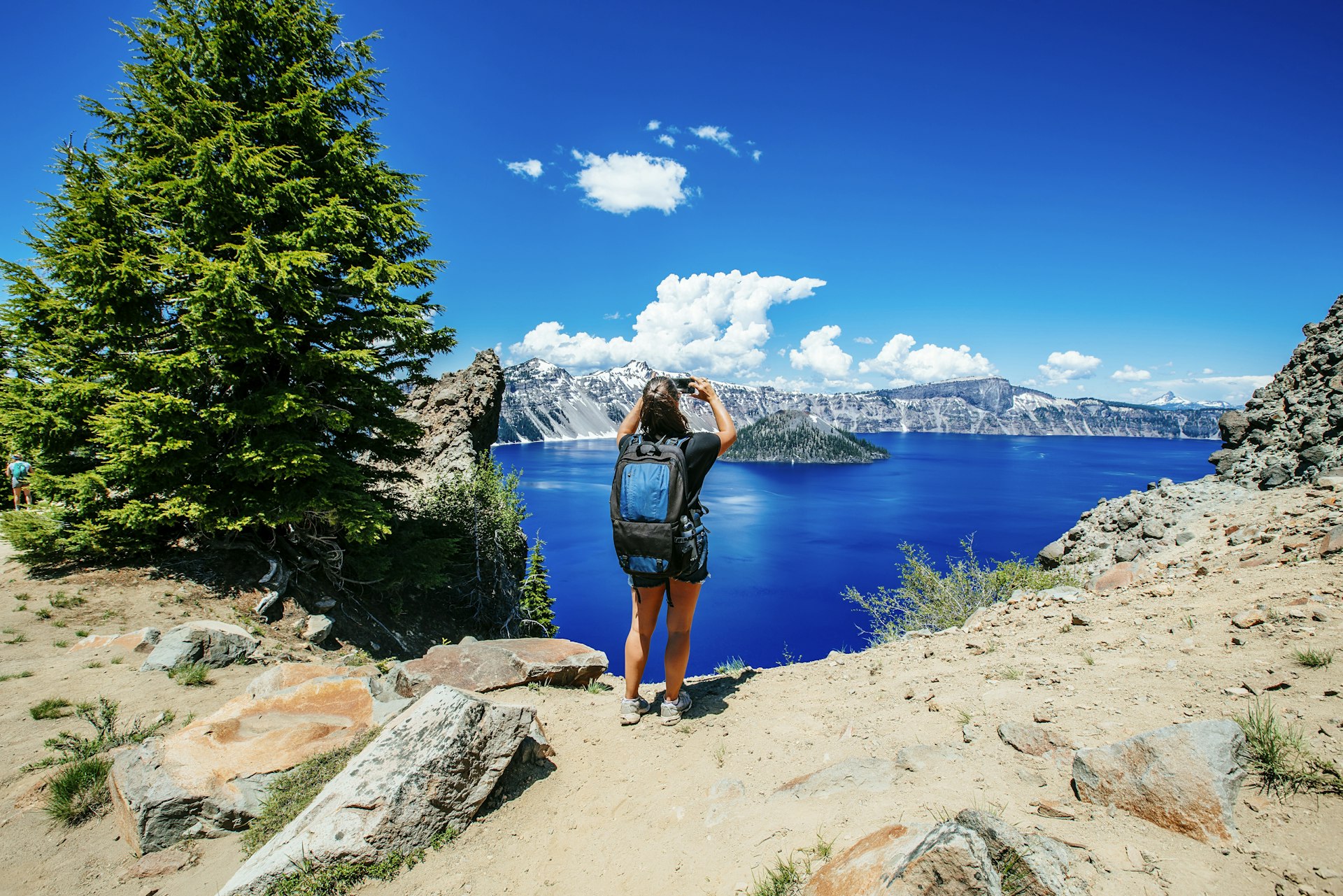 A backpacker stops to take in the splendor of Crater Lake National Park, Oregon