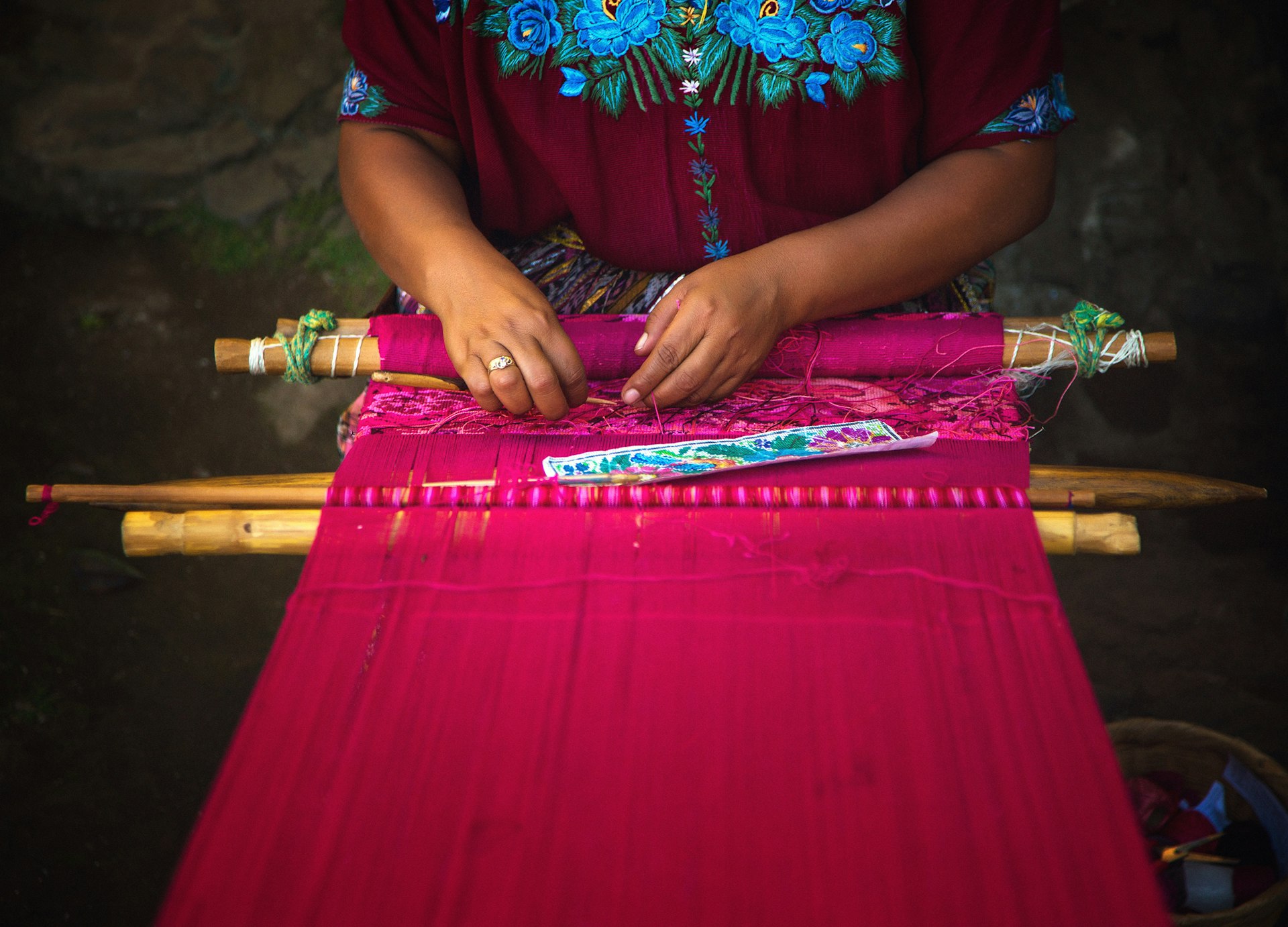 A Guatemalan Mayan woman weaving on a backstrap loom