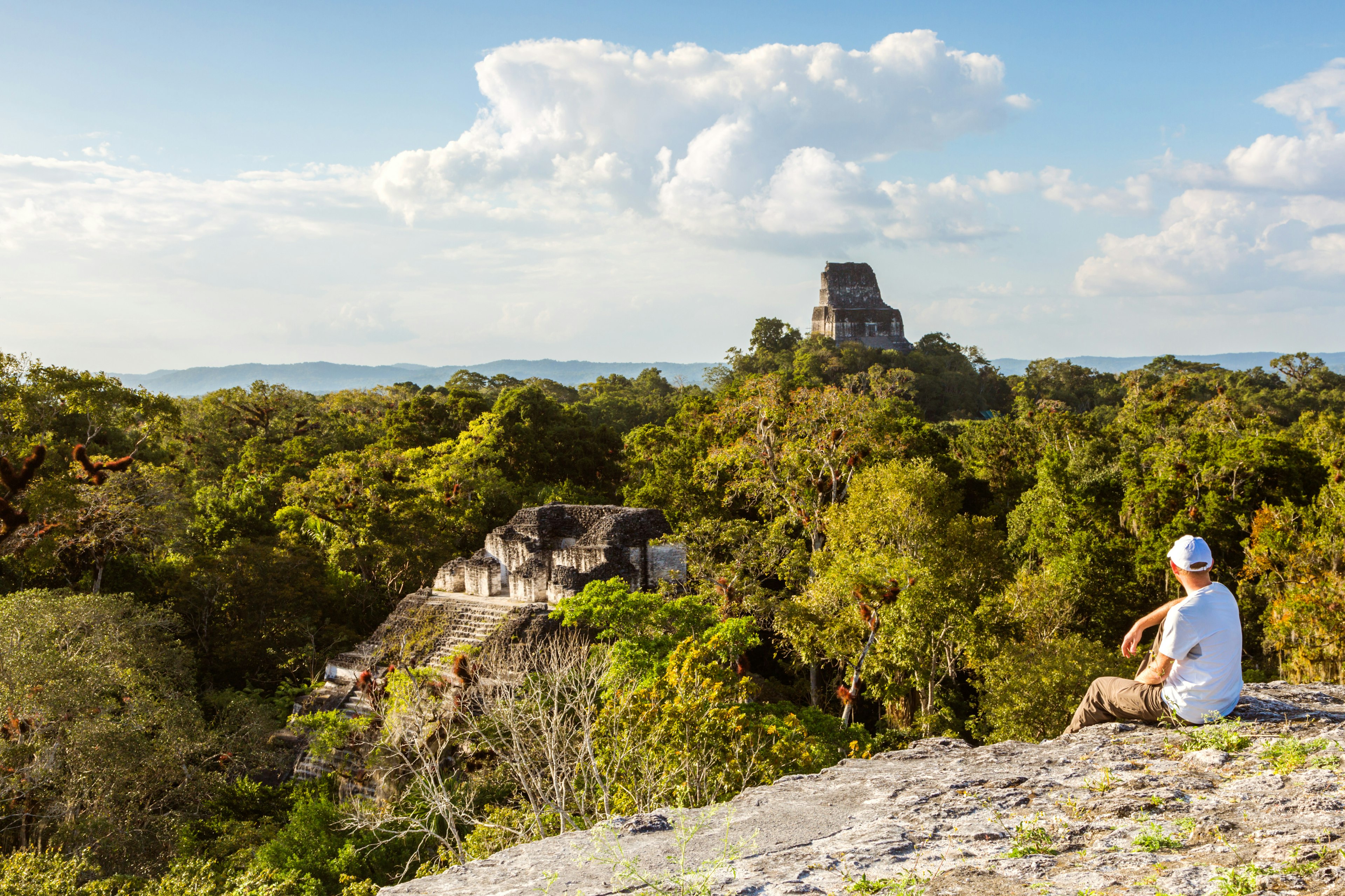 Tourist looking at the Mayan ruins of Tikal from Temple IV, Guatemala