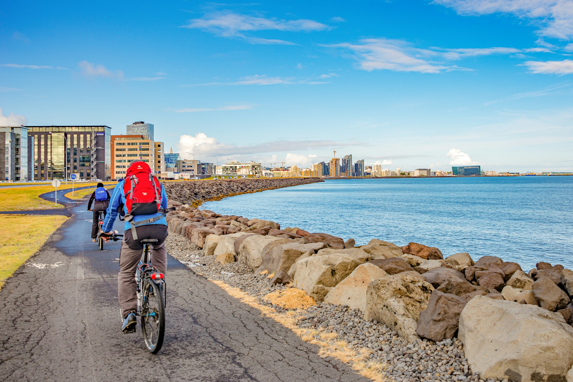 Cyclists following a shoreline cycle path in Reykjavik