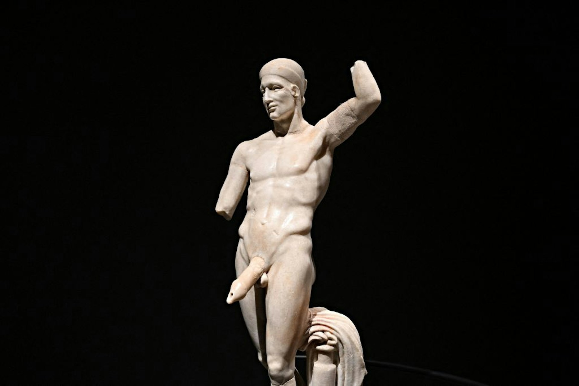 A "Statue-fountain of Priapus, symbol of prosperity" with a huge penis against a black background during a new exhibition in Pompeii's site entitled "Art and sensuality in the houses of Pompeii" on art and sexuality in the ancient city, where sculptures and paintings of breasts