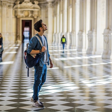 A man in a museum looks upward