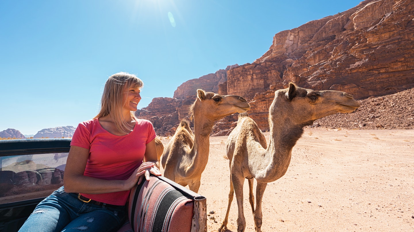 Tourist and camel in desert Wadi Rum, Jordan.; Shutterstock ID 1677705418; your: Brian Healy; gl: 65050; netsuite: Lonely Planet Online Editorial; full: Visa requirements for Jordan