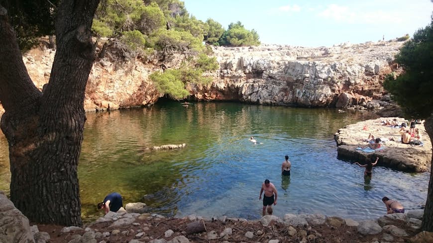 People swimming in Lokrum, which sits less than a mile across the water from Dubrovnik.