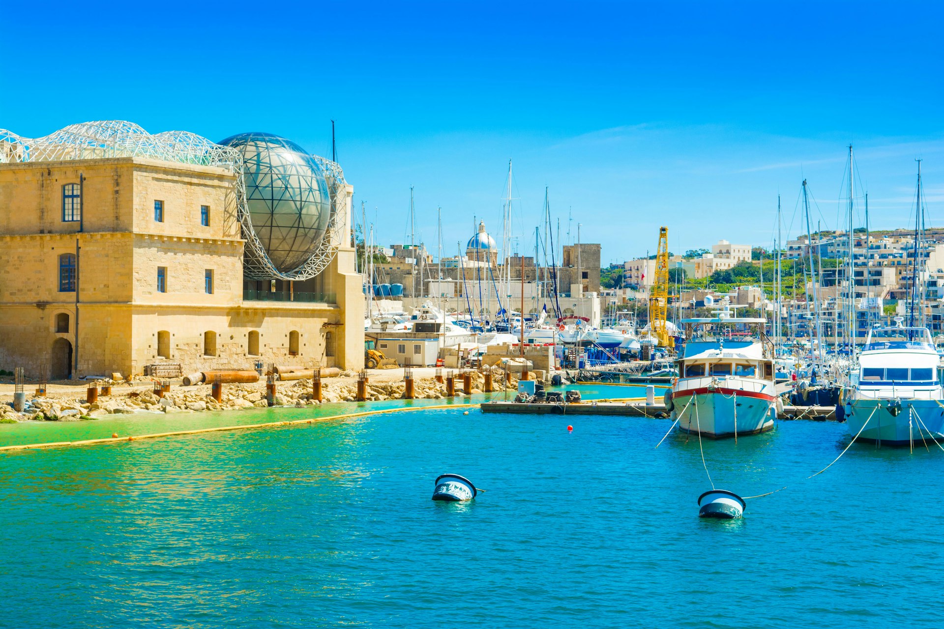 A view across the harbor to the Esplora Science Centre in Malta with its glass-domed roof