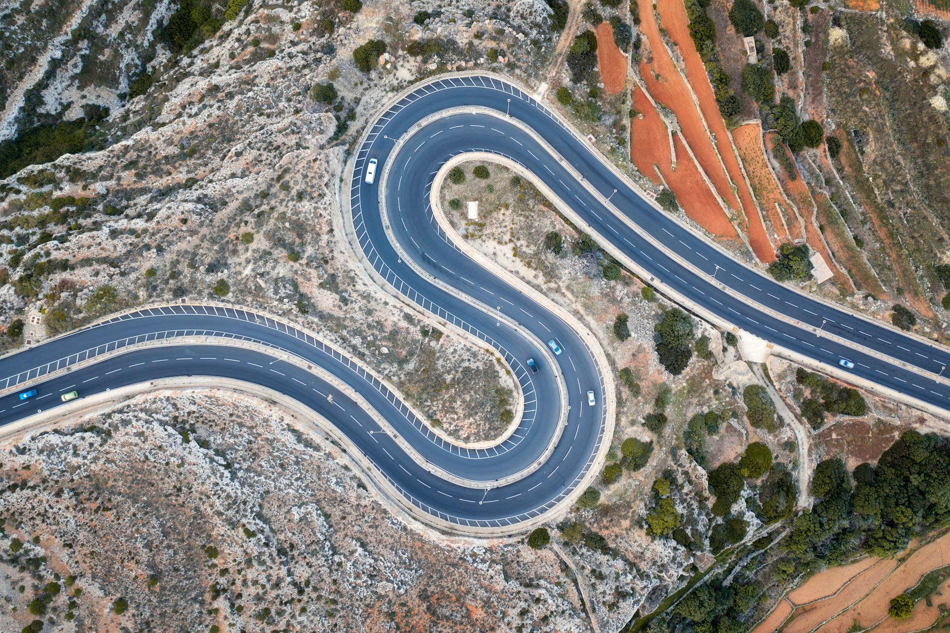 An overhead shot of curves on a mountain road in Malta, Europe