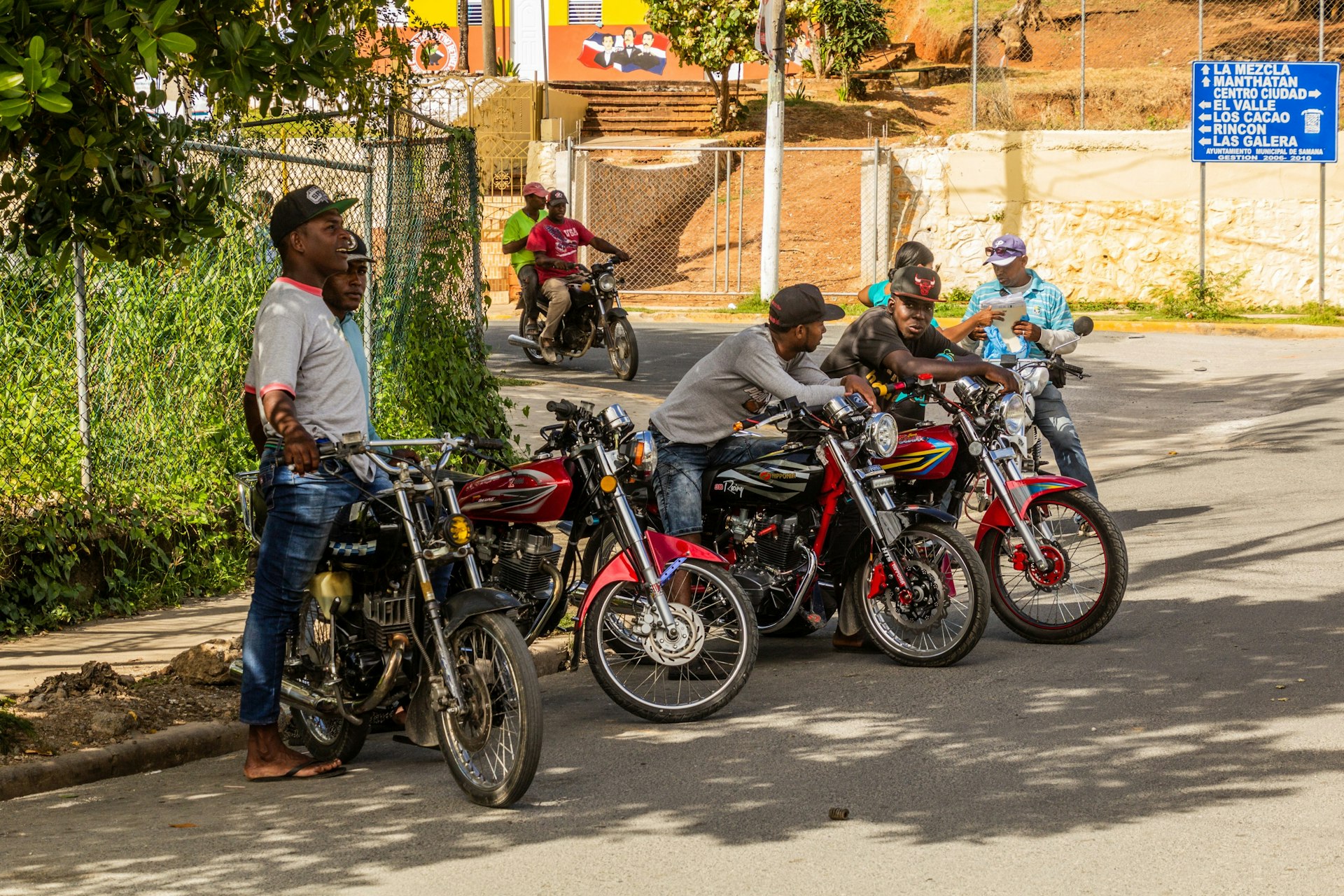 A group of motorbike drivers line up on the street waiting for passengers in Samana, Dominican Republic.