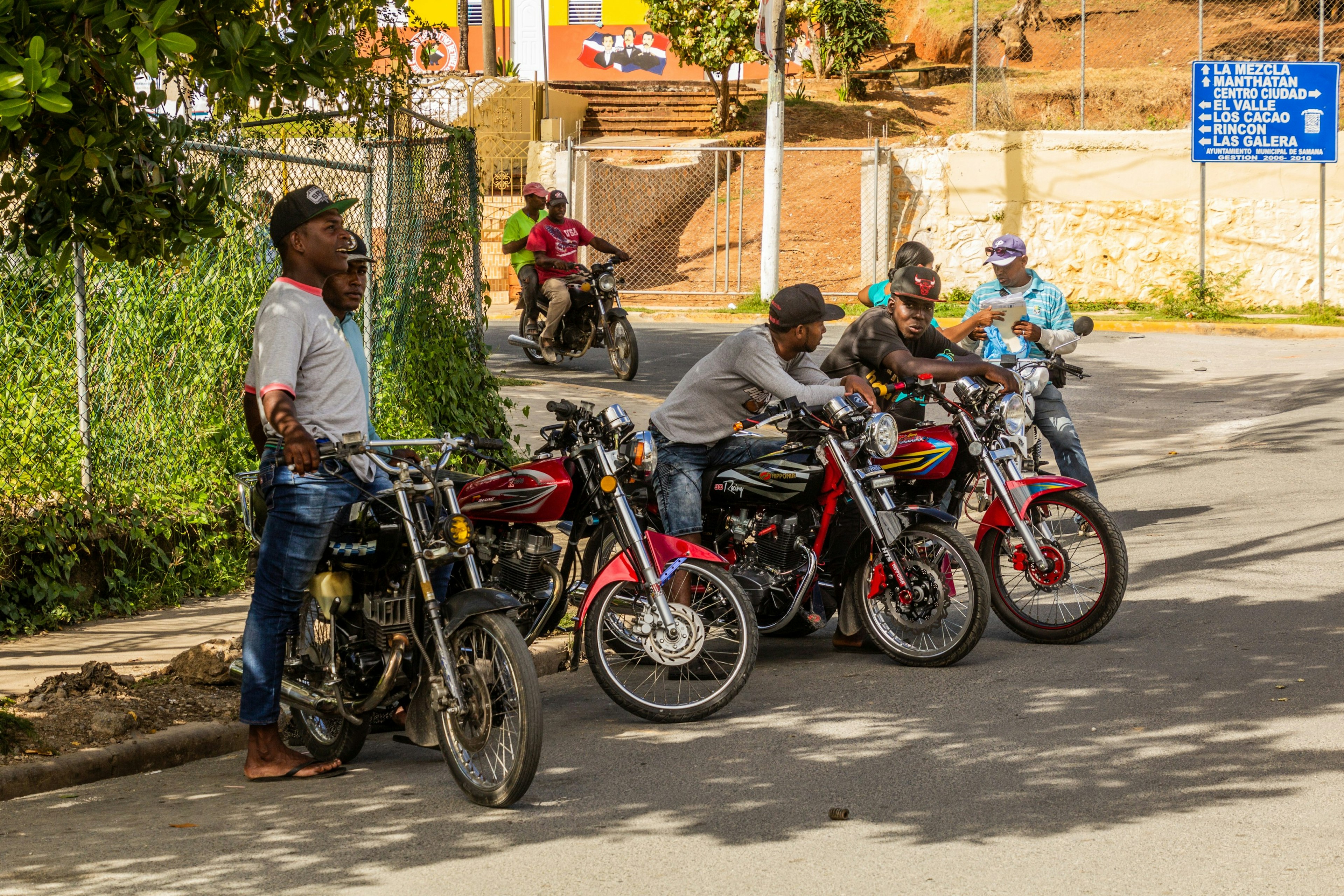 A group of motorbike drivers line up on the street waiting for passengers in Samana, Dominican Republic.