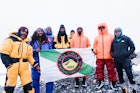 The Full Circle Everest team holding a flag