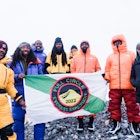 The Full Circle Everest team holding a flag
