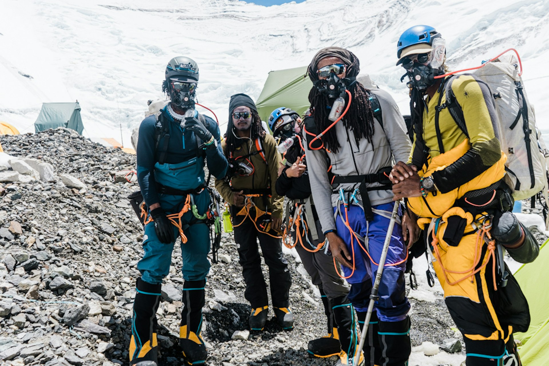 Members of the Full Circle Everest team standing together on rocky ground during the summit climb 