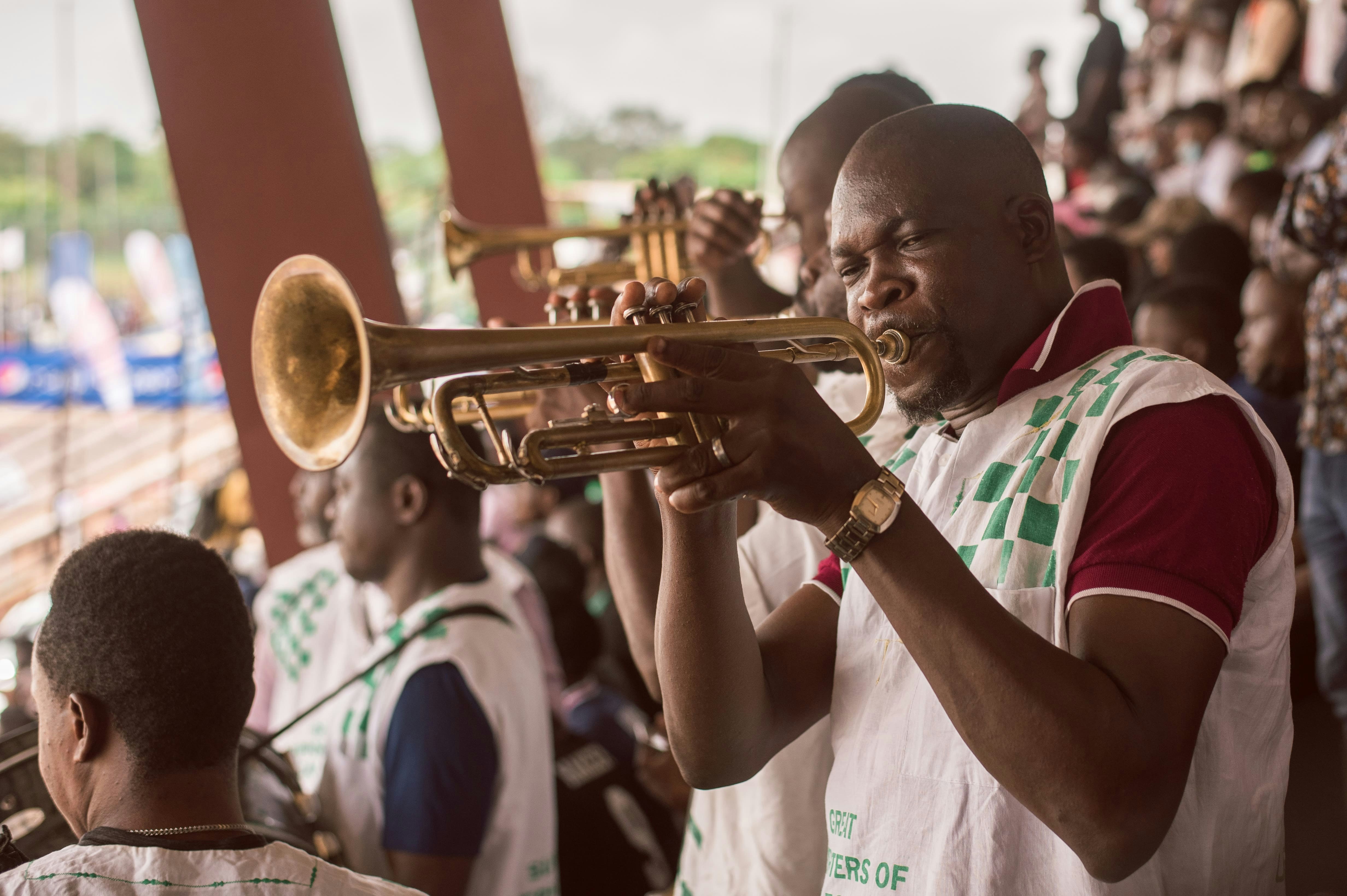 A band member blowing the trumpet during a football game at the Nigerian University games at the University of Lagos 