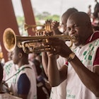 A band member blowing the trumpet during a football game at the Nigerian University games at the University of Lagos 