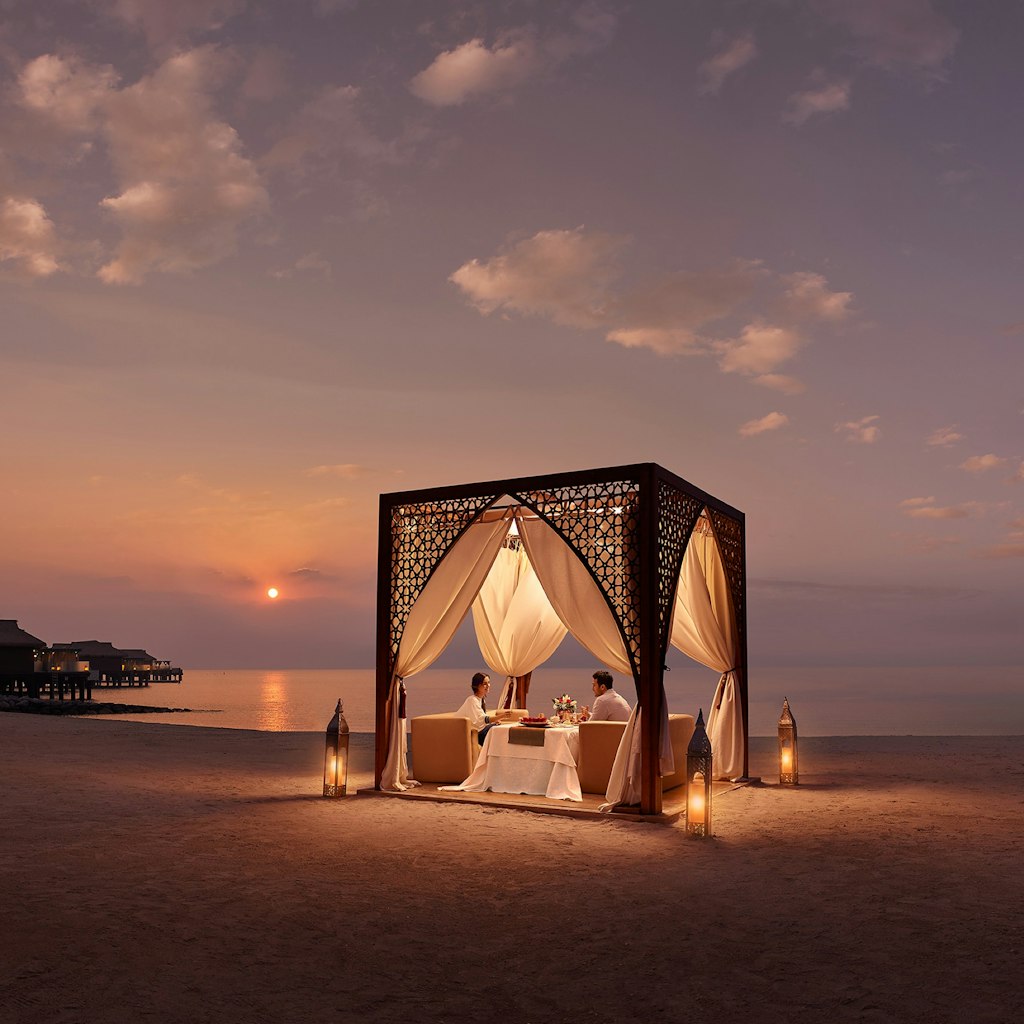 Dining in a cabana on the shore of the ocean in Qatar