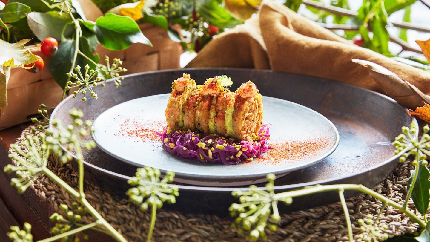 Vegetable rösti with creamed avocado, sweet and sour cabbage, smoked paprika tartar sauce and toasted pistachios.