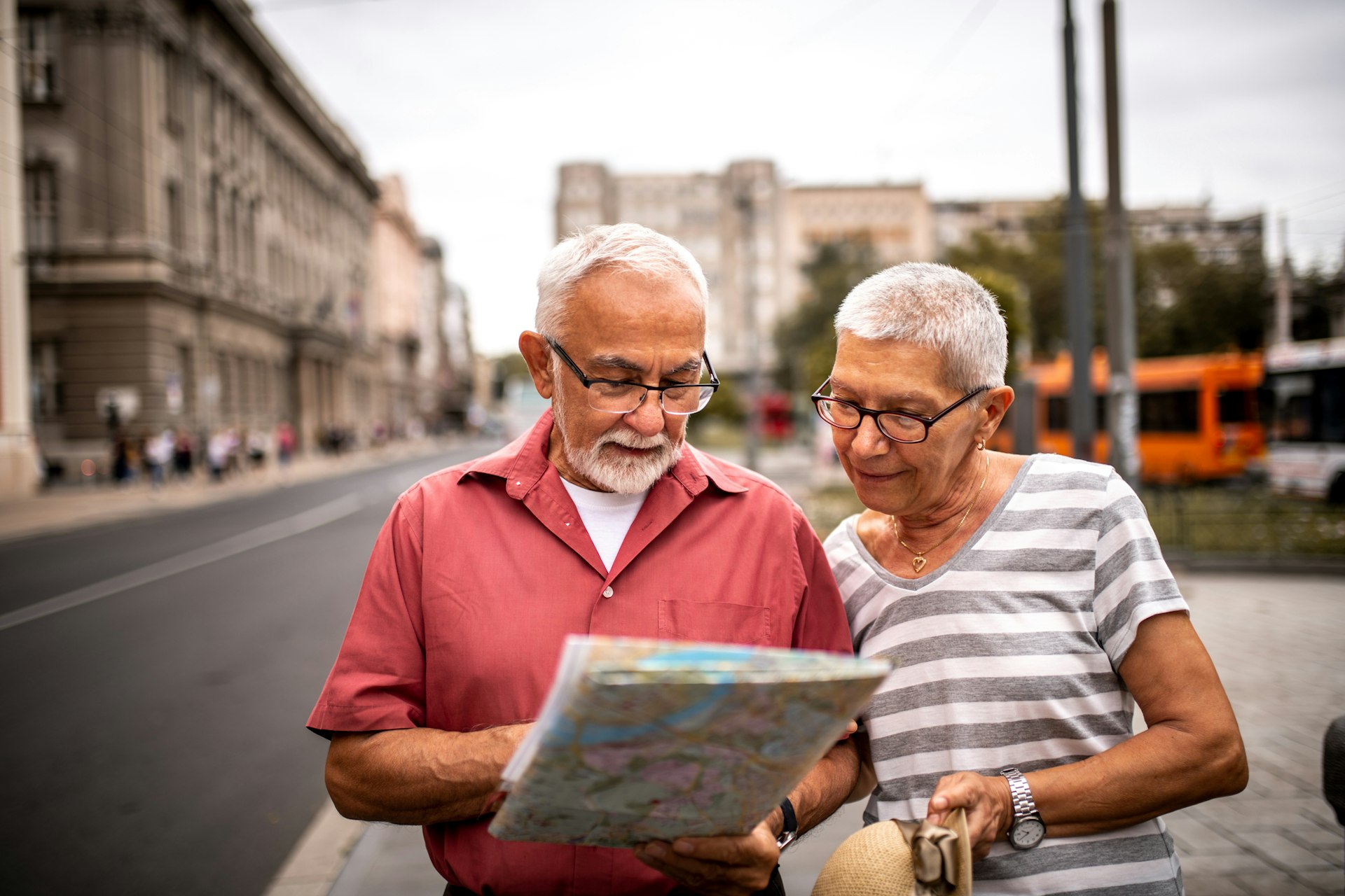 Senior couple looking at map in European city