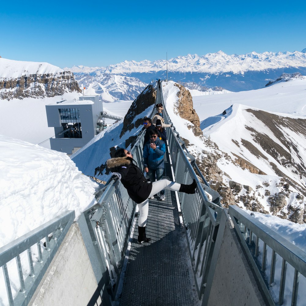 Tourists on Titlis Cliff Walk, a suspension bridge at Mount Titlis in Engelberg, Switzerland.