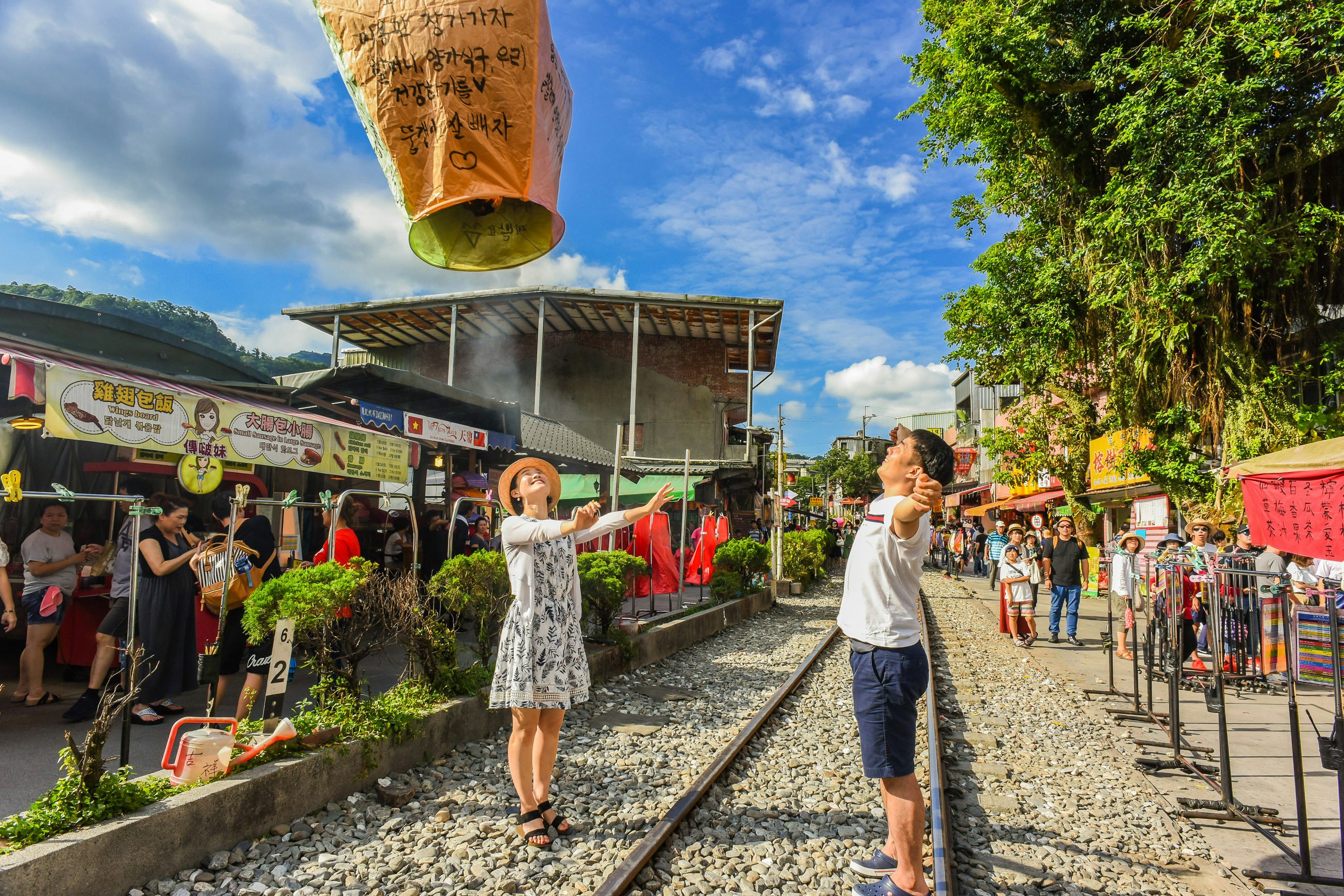Tourists launching sky lanterns along the Pingxi Railway line near Taipei