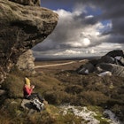 A female hiker rests on the Yorkshire moors