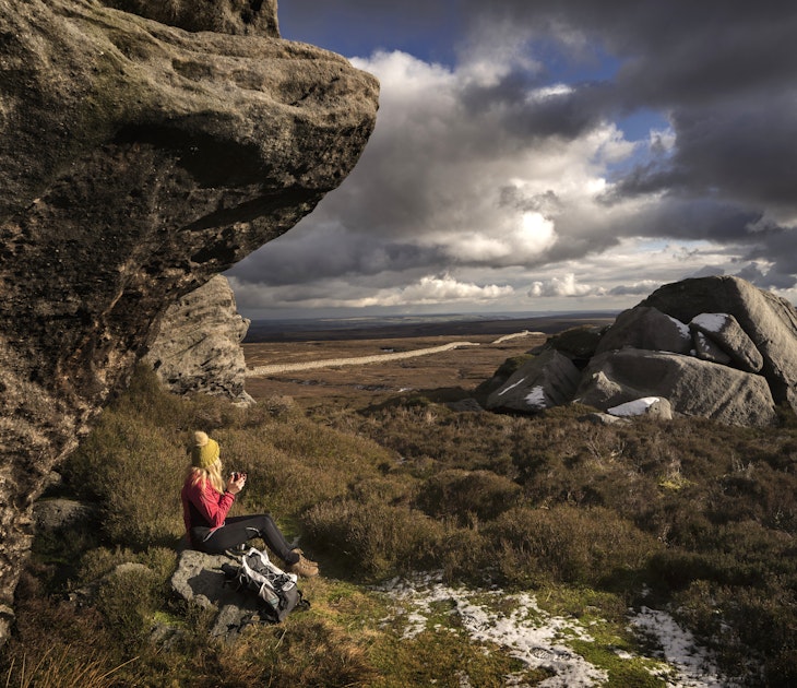 A female hiker rests on the Yorkshire moors