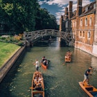 Cambridge, UK - August 20, 2017 : People punting in a canal next to the Mathematical bridge