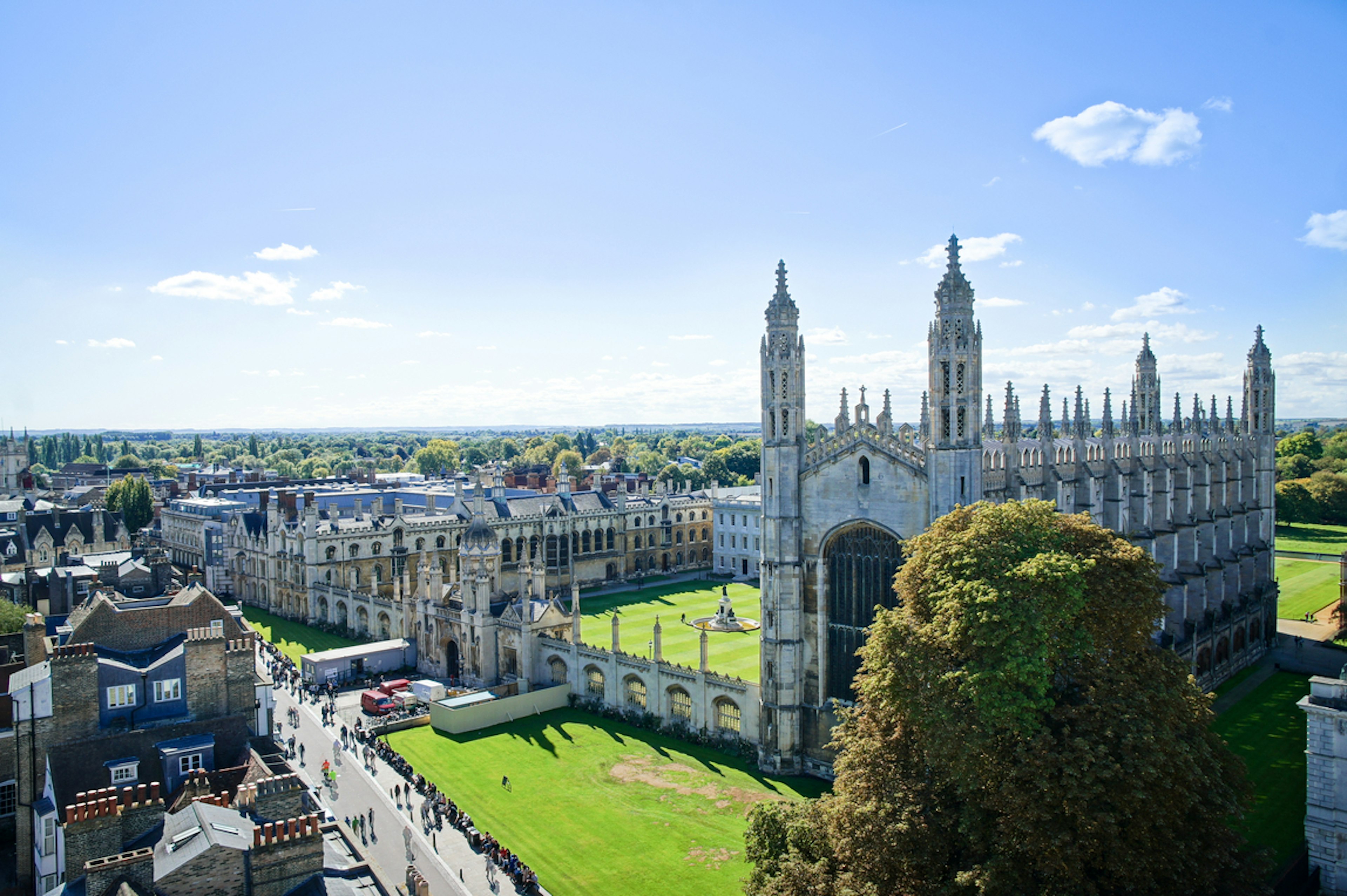 A large Gothic building on an open green, viewed from above, with spires