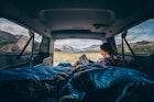 A woman camping in a van in Alaska