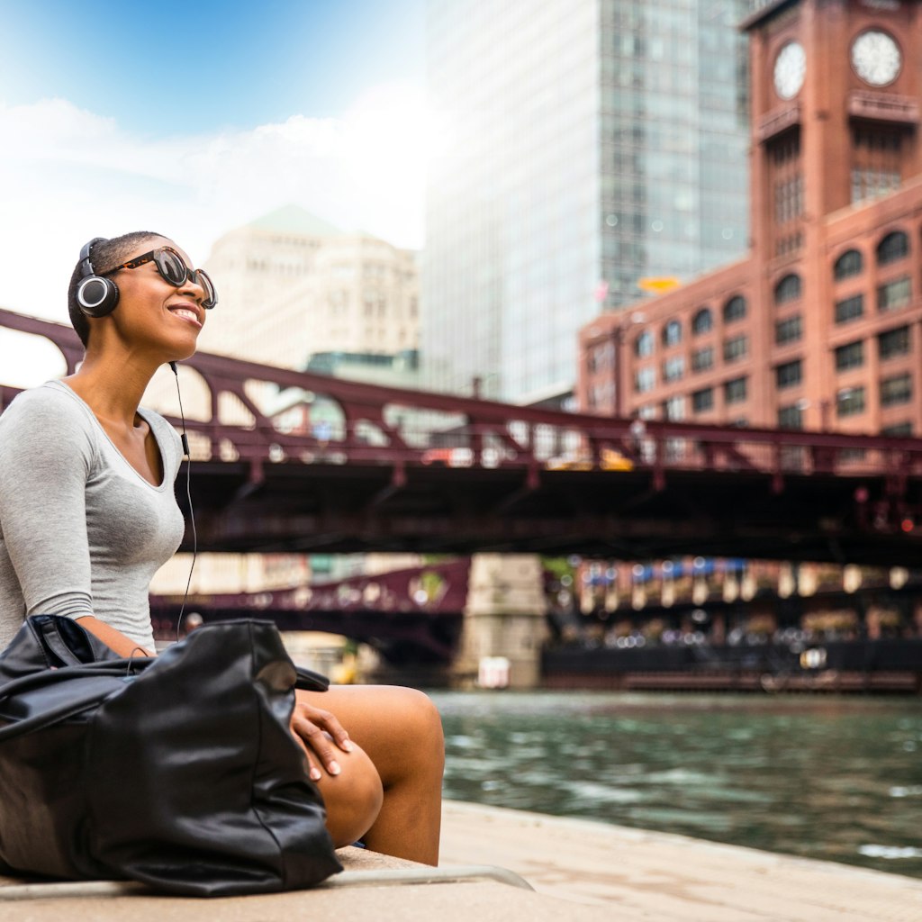 Woman listening to music by the Chicago River