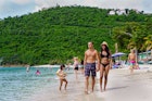 Magen's Bay, St Thomas United States Virgin Islands - August 18 2019: Happy, mixed race, South Asian couple walking beside the water at Magens Bay Beach in St. Thomas United States Virgin Islands.; Shutterstock ID 1972015679; your: Brian Healy; gl: 65050; netsuite: Lonely Planet Online Editorial; full: Best things to do in St Thomas