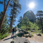 Hikers walk towards Devils Tower National Monument in Wyoming